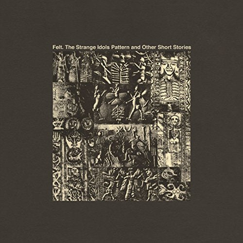 "Black and white vinyl album cover with intricate carvings on a dark background."
