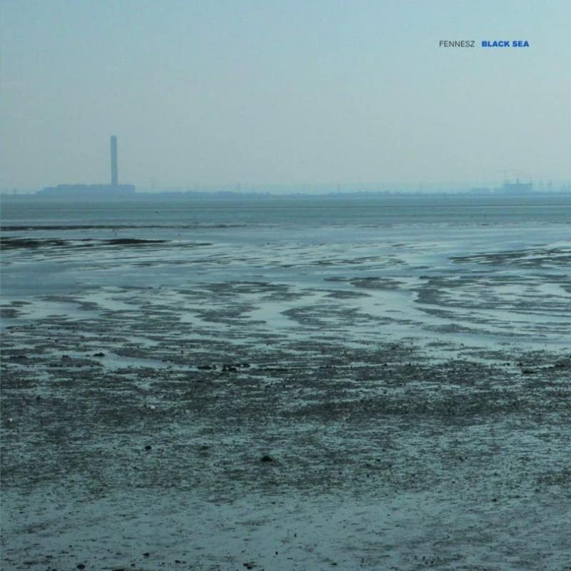 Album cover for Fennesz’s “Black Sea” showing a grey, flat coastal landscape.