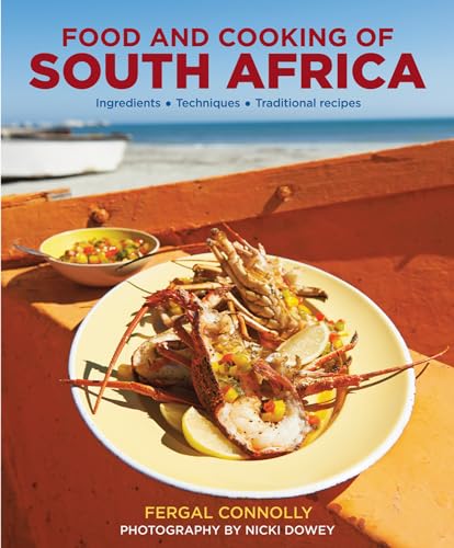 Cookbook cover featuring a plate of lobster on an orange boat by the sea.