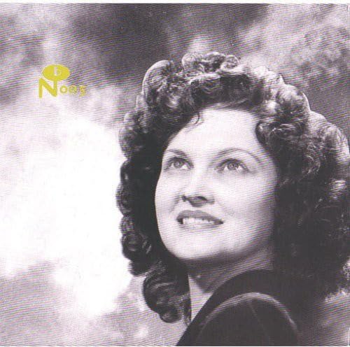 Black and white portrait of a woman with curly hair looking upward.