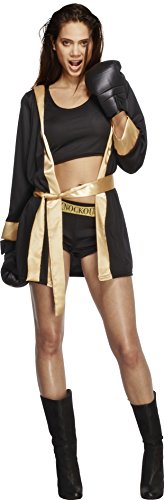 Woman wearing black boxing gloves, jacket, shorts, and boots, with beige accents, standing confidently.