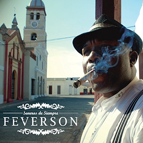 Man in a hat smoking a cigar, church in the background.