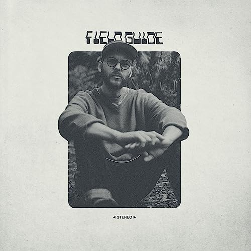 Black and white album cover featuring a man wearing a cap and sweater.