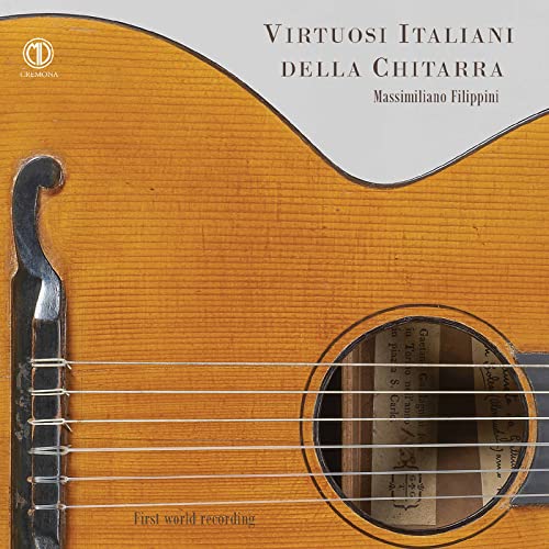 Close-up of a classical guitar with sheet music visible inside.