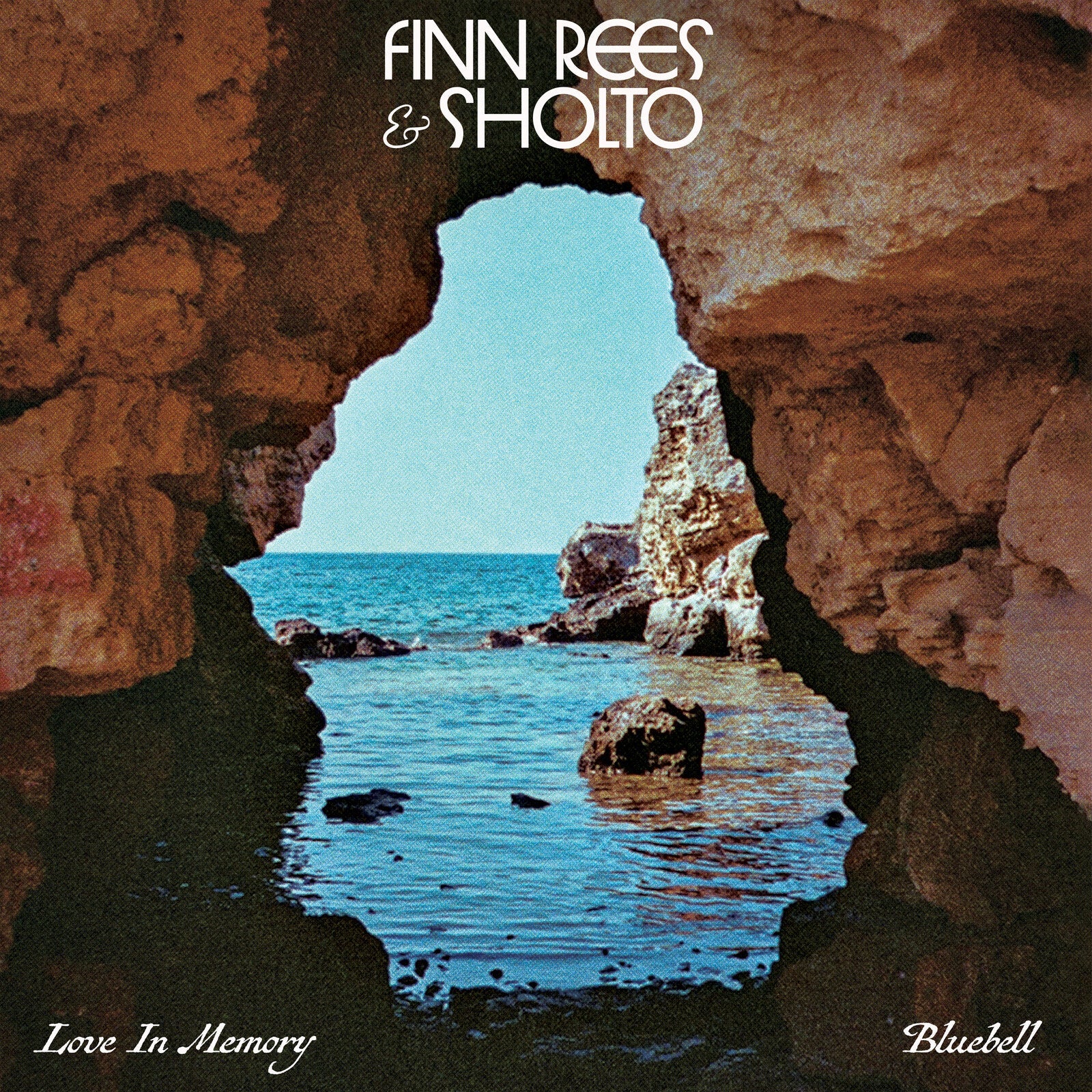 Vinyl record cover: coastal view framed by a dark rock archway.