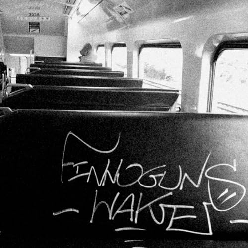 Black and white album cover with graffiti and a train interior.