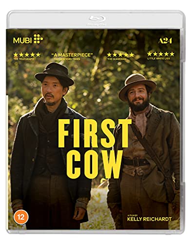 Blu-ray cover for First Cow featuring two men in hats standing in a forest.