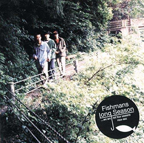 Three men walk along a wooded path with a circular album cover graphic below.