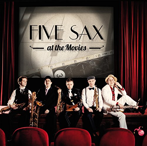 Five musicians with saxophones in front of a movie screen.