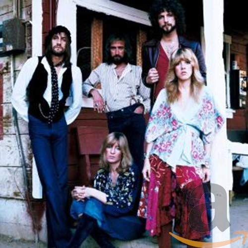 Fleetwood Mac band portrait with five members in 1970s attire.