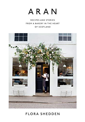 Book cover featuring a white bakery storefront with floral decor and a person entering.