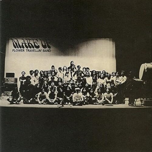 Black and white photo of a large group of people posing on a stage.