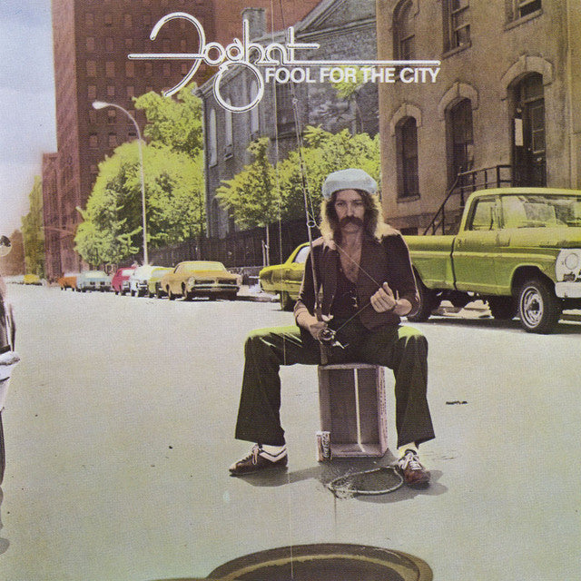 Foghat’s “Fool For The City” album cover: man with guitar in a city street.