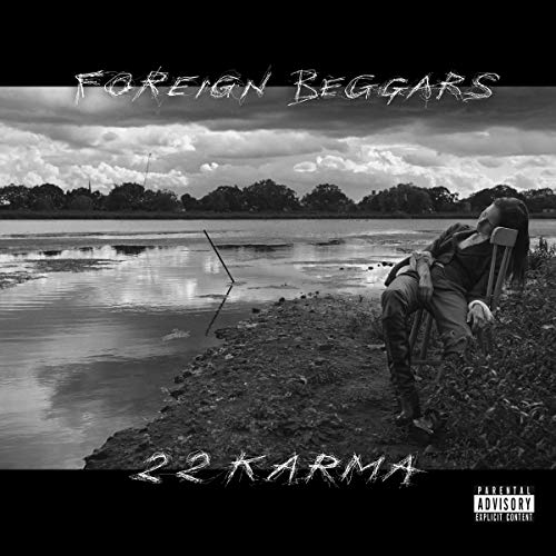 "Black and white vinyl album cover with a man sitting by a body of water."