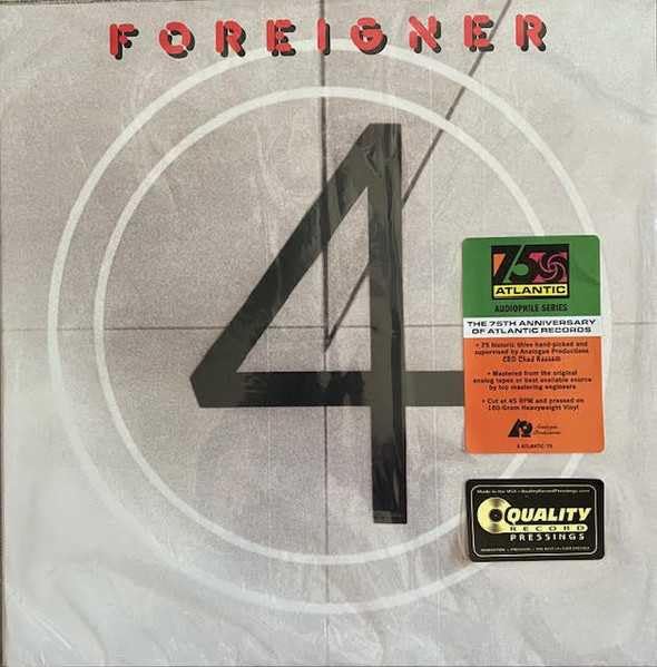 Foreigner’s “4” vinyl record cover with a large black number four and stickers.