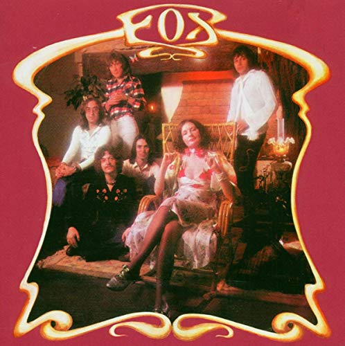 The band Fox posing in a vintage room, framed by a decorative gold border.