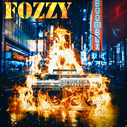 A boombox engulfed in flames against a blurry, neon-lit city street background.