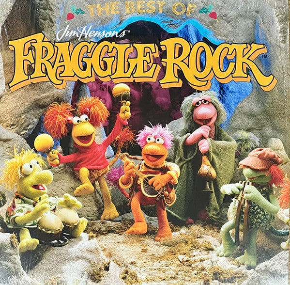 Fraggle Rock characters with musical instruments in front of a cave.