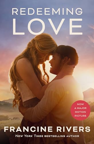 A man and woman embrace in a field at sunset on this book cover.