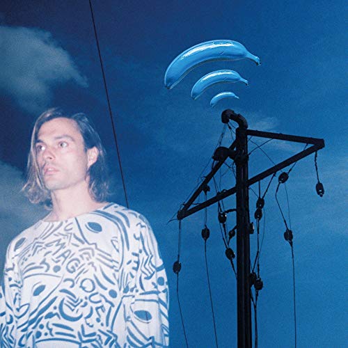 Album cover: man, blue banana shapes, and a complex black structure.