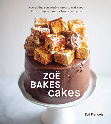 Cookbook cover featuring a chocolate cake topped with caramelized sugar cubes.