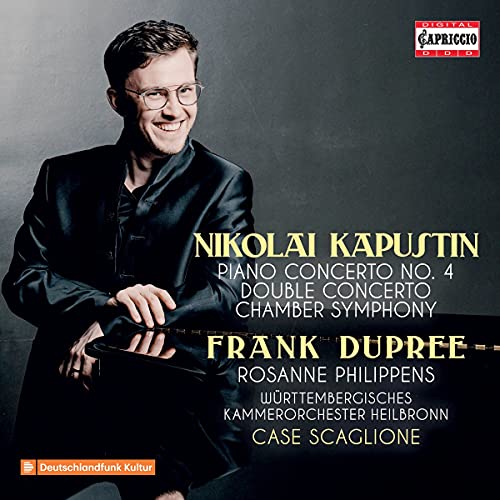 Album cover featuring a smiling man in a black suit sitting at a piano.