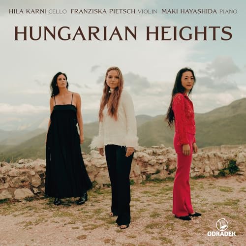 CD cover: three women standing on a stone wall with mountains.