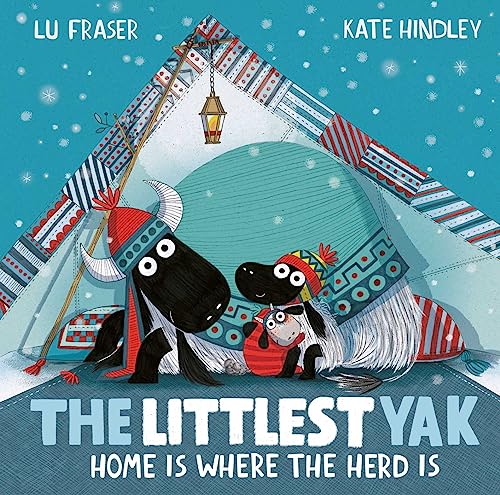Two yaks wearing winter hats sit inside a patterned tent during a snowfall.