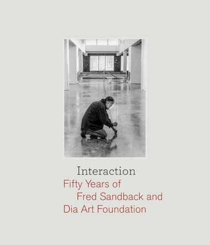Black and white photo of artist Fred Sandback installing linear sculptures.