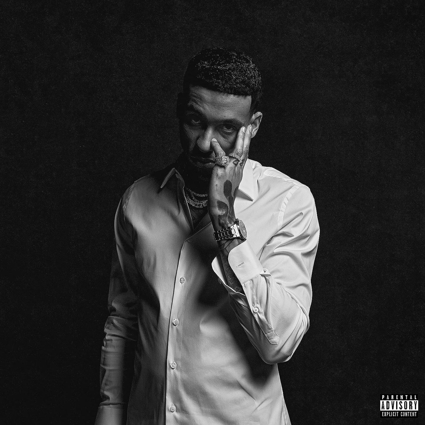 "Black and white album cover featuring a man in a white shirt."