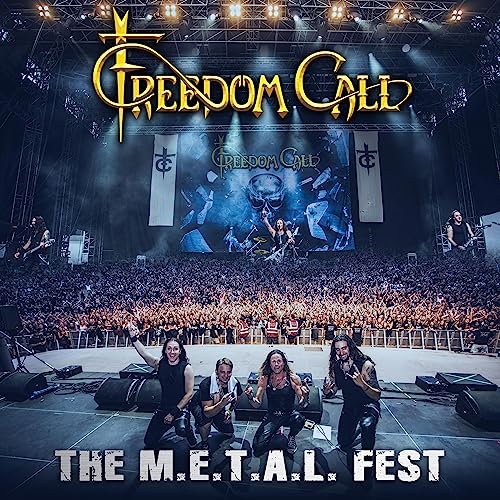 Freedom Call band members kneeling on stage before a large, cheering concert crowd.