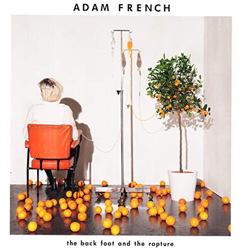 Person sitting in a chair connected by IV tubes to an orange tree with oranges.