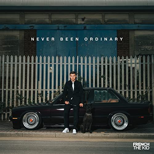 Album cover: man in suit with car and dog, blue background.