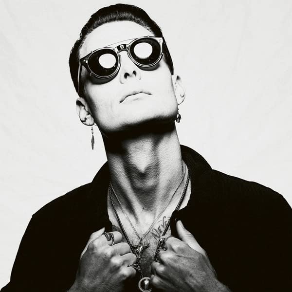 Black and white portrait of a man wearing large round sunglasses.