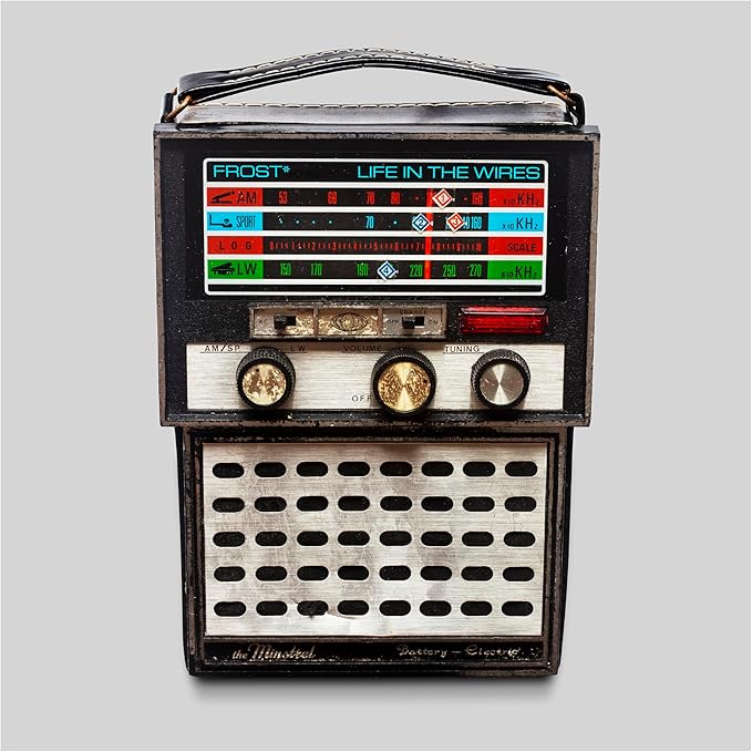 Vintage radio with “Life In The Wires” album art on its faceplate.
