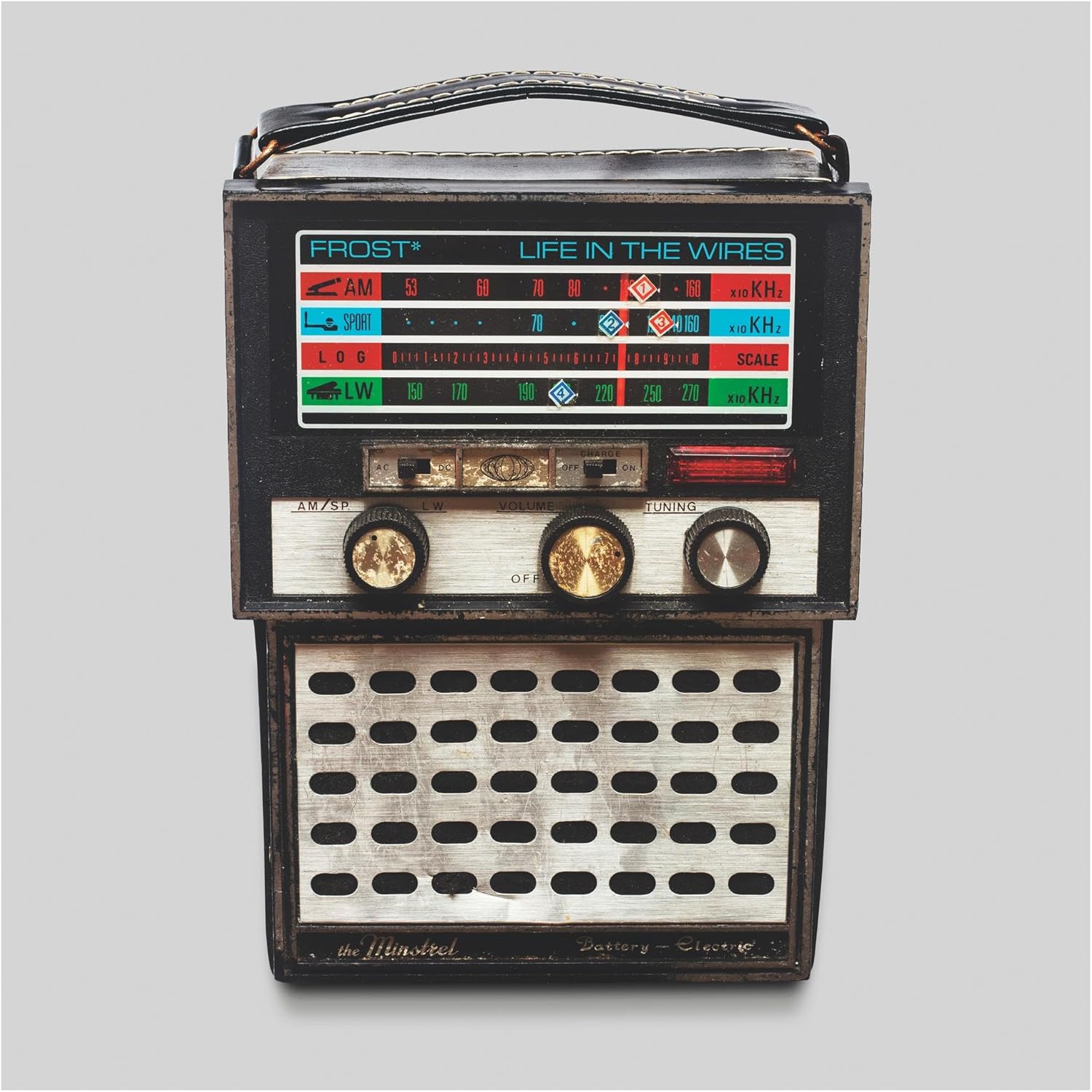 Vintage radio with “Life In The Wires” CD case resting on top.