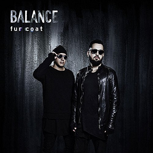 "Album cover featuring two men in dark clothing and sunglasses against a dark background."