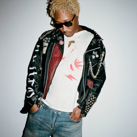 Future poses in a studded leather jacket, blonde hair, and sunglasses.
