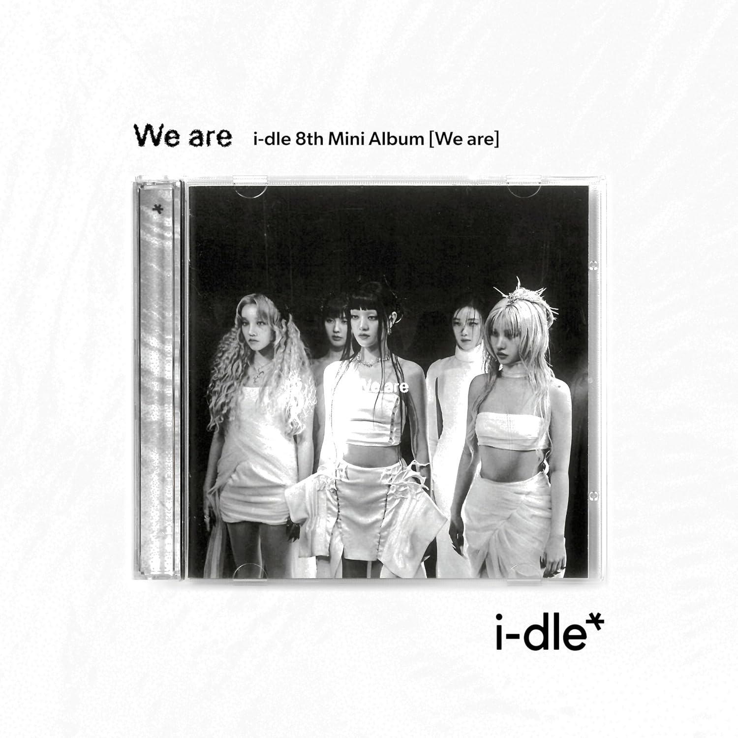 CD jewel case showing (G)I-DLE members in white outfits against a black background.