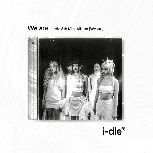 CD jewel case showing (G)I-DLE members in white outfits against a black background.