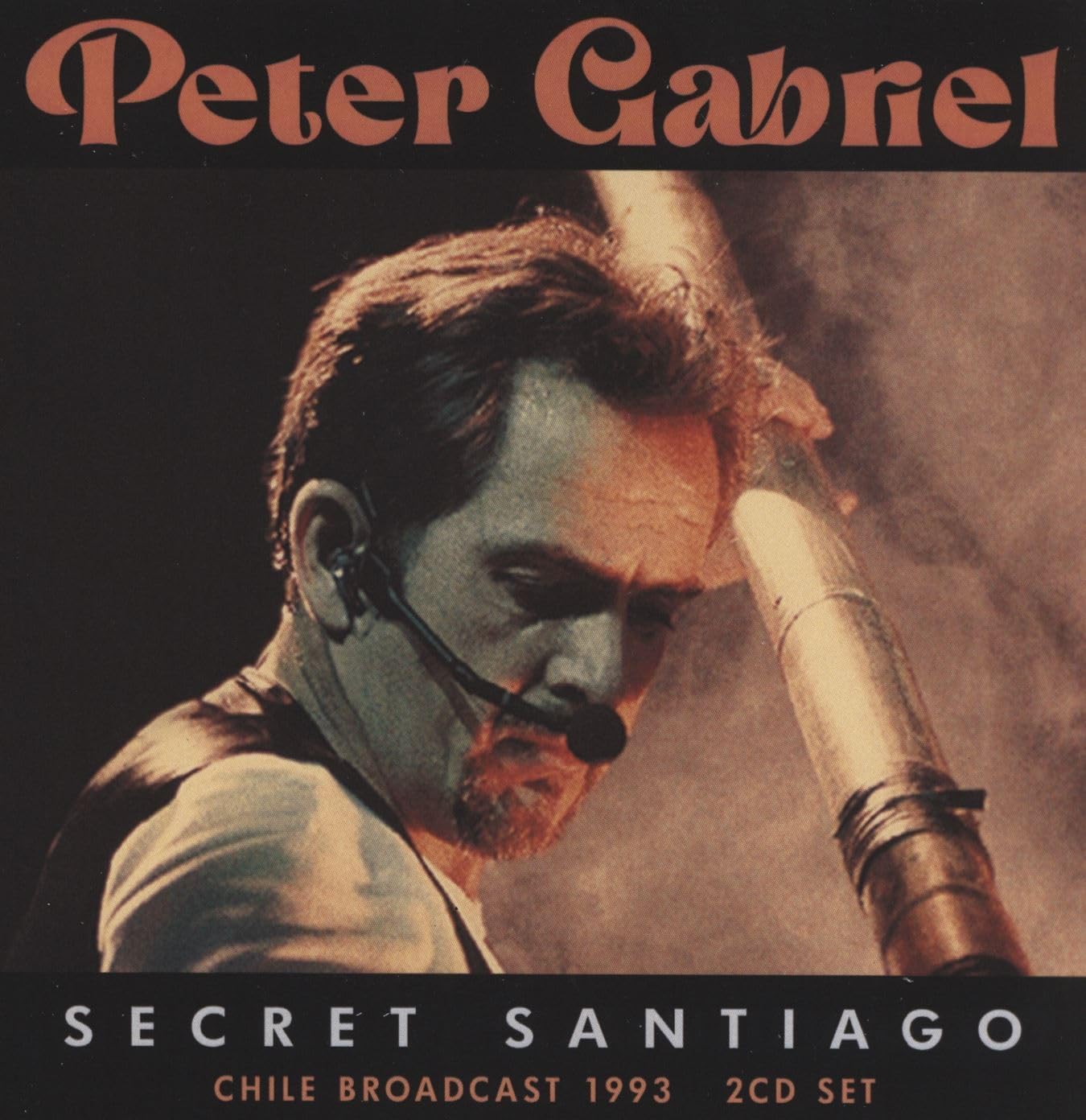 Peter Gabriel performing live with a headset microphone on the Secret Santiago CD cover.
