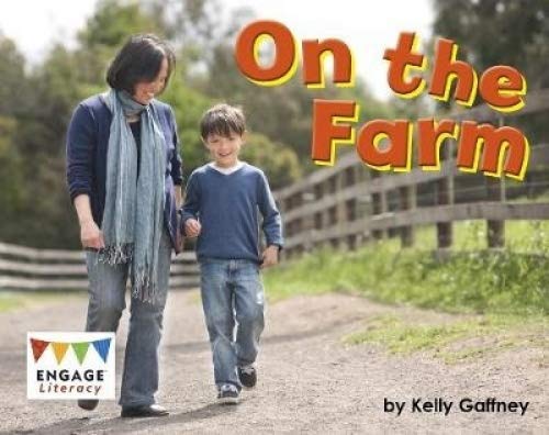 Woman and boy walking on a dirt path near a farm.