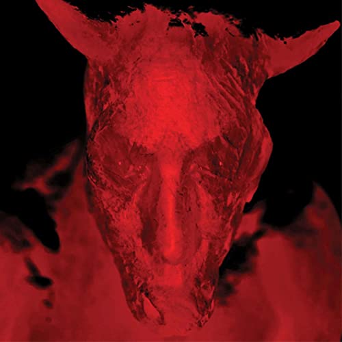 Red, distorted image of a skull or demonic face, dark background.