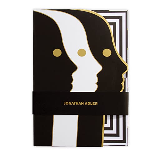Black notebook with die-cut face design and gold accent details.