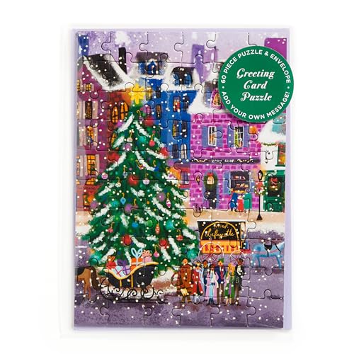 Christmas village scene puzzle card with a decorated tree and snowy rooftops.