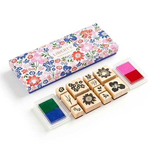 Floral patterned box with wooden rubber stamps and ink pads.