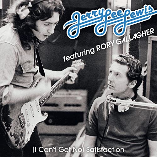 Black and white photo of Rory Gallagher playing guitar while Jerry Lee Lewis watches.