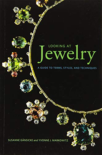 Book cover featuring a gold necklace with colorful gemstones on a black background.