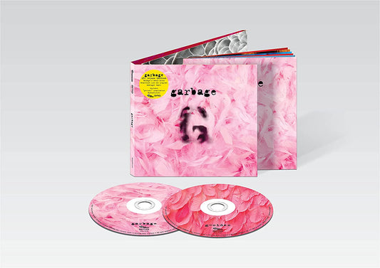 "Garbage album packaging: pink marbled box with CDs and booklet inside."