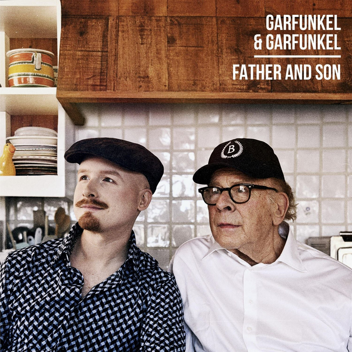 Art Garfunkel and his son standing in a kitchen with text overlay.